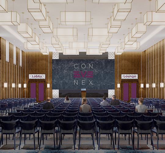 Events | Auditoriumssaal mit vielen Stühlen, Bühne und Besuchern